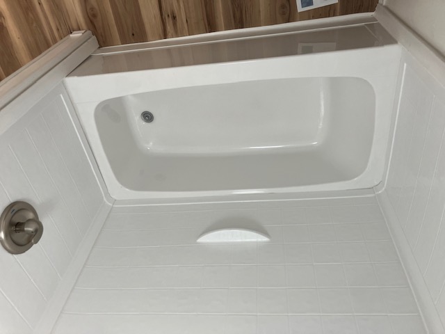 White bathtub and shower in mobile home for sale near Visalia, Rancho Exeter
